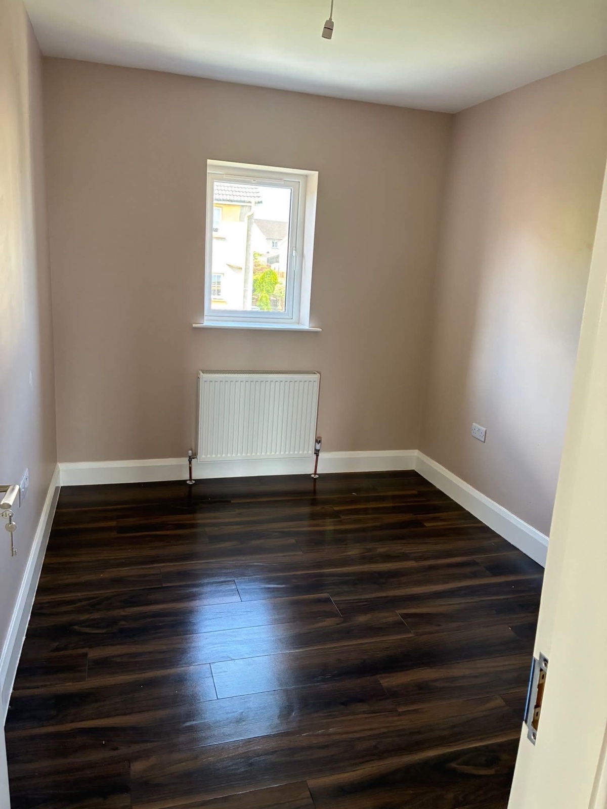 Empty bedroom after cleaning with a clear polished floor, ready for moving in